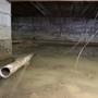Flooded crawl space with murky water and a partially submerged pipe; exposed support beams above.