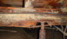 moldy rotten wood joist with rusty jack