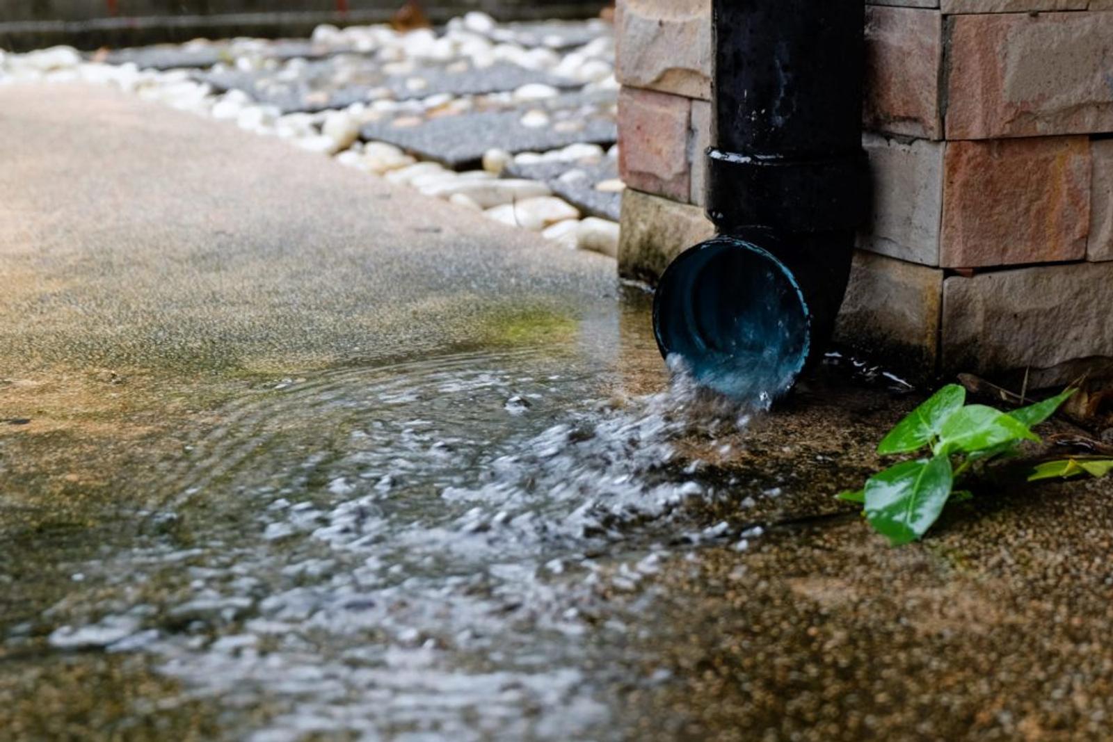 Water coming out of downspout and pooling onto concrete