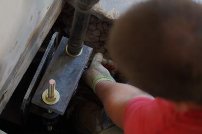 Crew installing bolts on push pier - close up