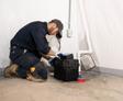 Crew in Basement installing sump pump