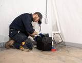 Crew in Basement installing sump pump