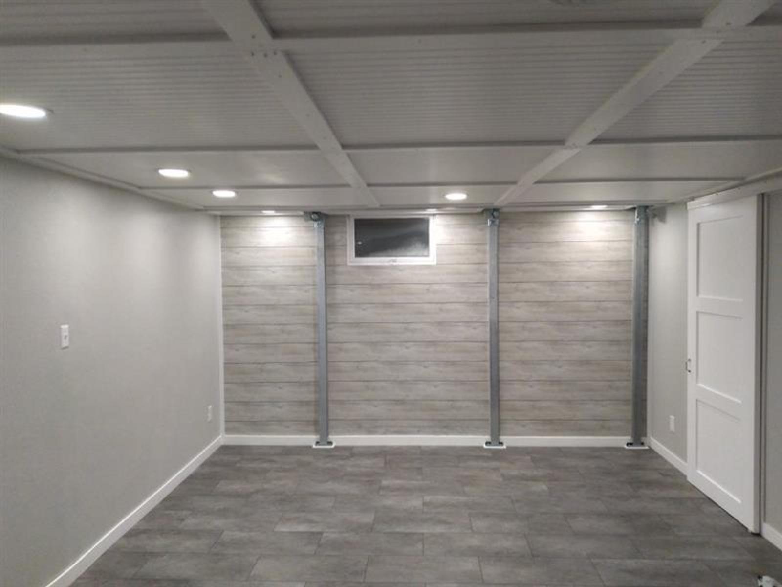 Minimalist room with gray walls, a small window, recessed lighting, and tiled floor.