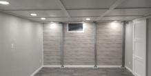Minimalist room with gray walls, a small window, recessed lighting, and tiled floor.
