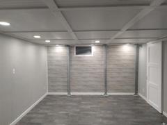 Minimalist room with gray walls, a small window, recessed lighting, and tiled floor.