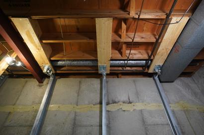 Shot of IntelliBrace wall support on concrete wall and brackets attached to joist