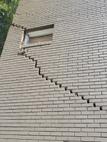Stairstep crack in large brick wall on home