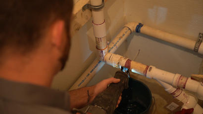 Crew sawing PVC pipe