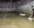 flooded crawl space with bucket and wires