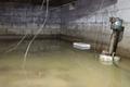 flooded crawl space with bucket and wires