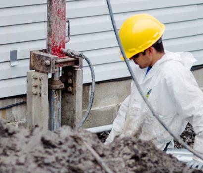 Crew in PPE installing push piers