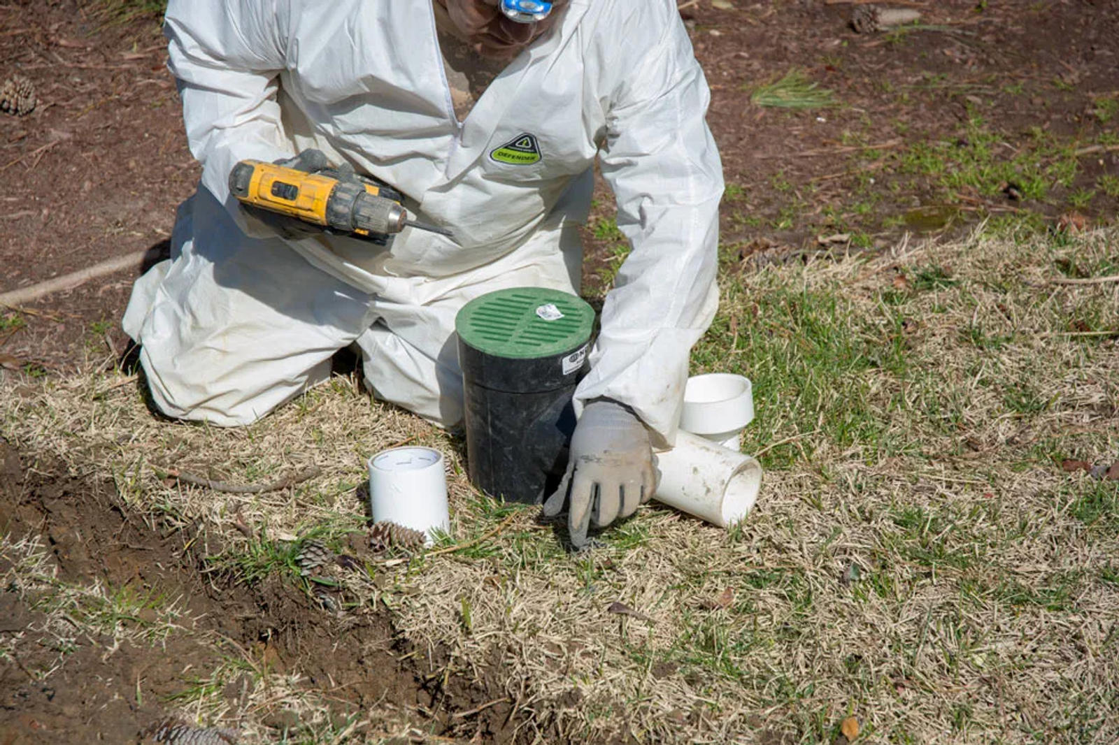 Worker installing a yardwell