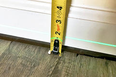 Measuring interior sagging floors.