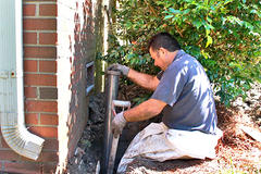 The production crew is installing a push pier on a brick foundation.