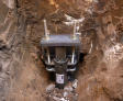 Close-up of a metal foundation support system installed in a dirt trench.