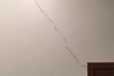 Vertical crack on interior doorway wall.
