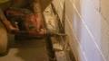 Crew drilling weep holes in the basement wall.