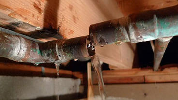 Close-up of a busted leaking pipe cropped.