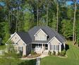 drone shot of a house surrounded by trees