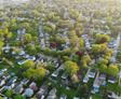 Aerial shot of neighborhoods with a lot of trees.