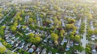 Aerial shot of neighborhoods with a lot of trees.