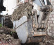 Bobcat grabbing shoveling soil.