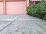 A lifted and leveled driveway with a view of the garage.