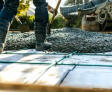 Close-up of crew shoveling poured cement.
