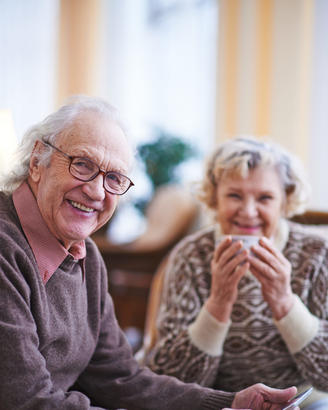 An elderly couple smiling.