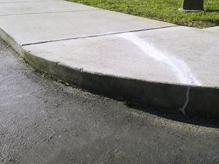 Sidewalk's curb lifted and leveled, the after shot.