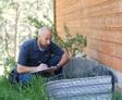 Groundworks inspector evaluates exterior foundation wall and egress.