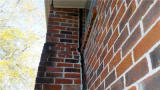 Chimney separating from the brick exterior foundation wall.