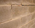 Interior bowing cinderblock wall.
