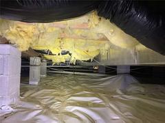 Torn vapor barrier and falling insulation in crawlspace.