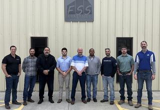 FSS staff outside of the warehouse.