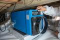 Crew installing Dehumidifier in crawlspace.