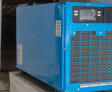 A blue industrial dehumidifier placed on a black platform.