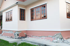 House exterior with cracked walls and damaged foundation.