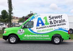 Green plumbing van with "A1 Sewer & Drain" logo and contact info on the side, parked on a street.