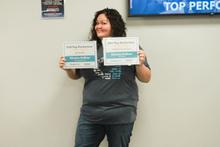 Kristin DeBoer, Top Performer Employee, smiling, holding awards.