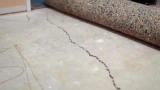 Interior cracked concrete slab.