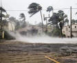trees bending from wind, and water kicking up from a storm