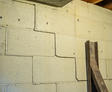 Stairstep cracks on the interior cinderblock wall.