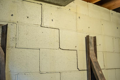 Stairstep cracks on the interior cinderblock wall.