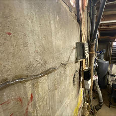 Interior cinderblock wall with foundation crack.