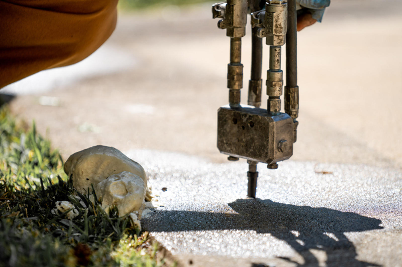 A close-up of poly being injected into the concrete.