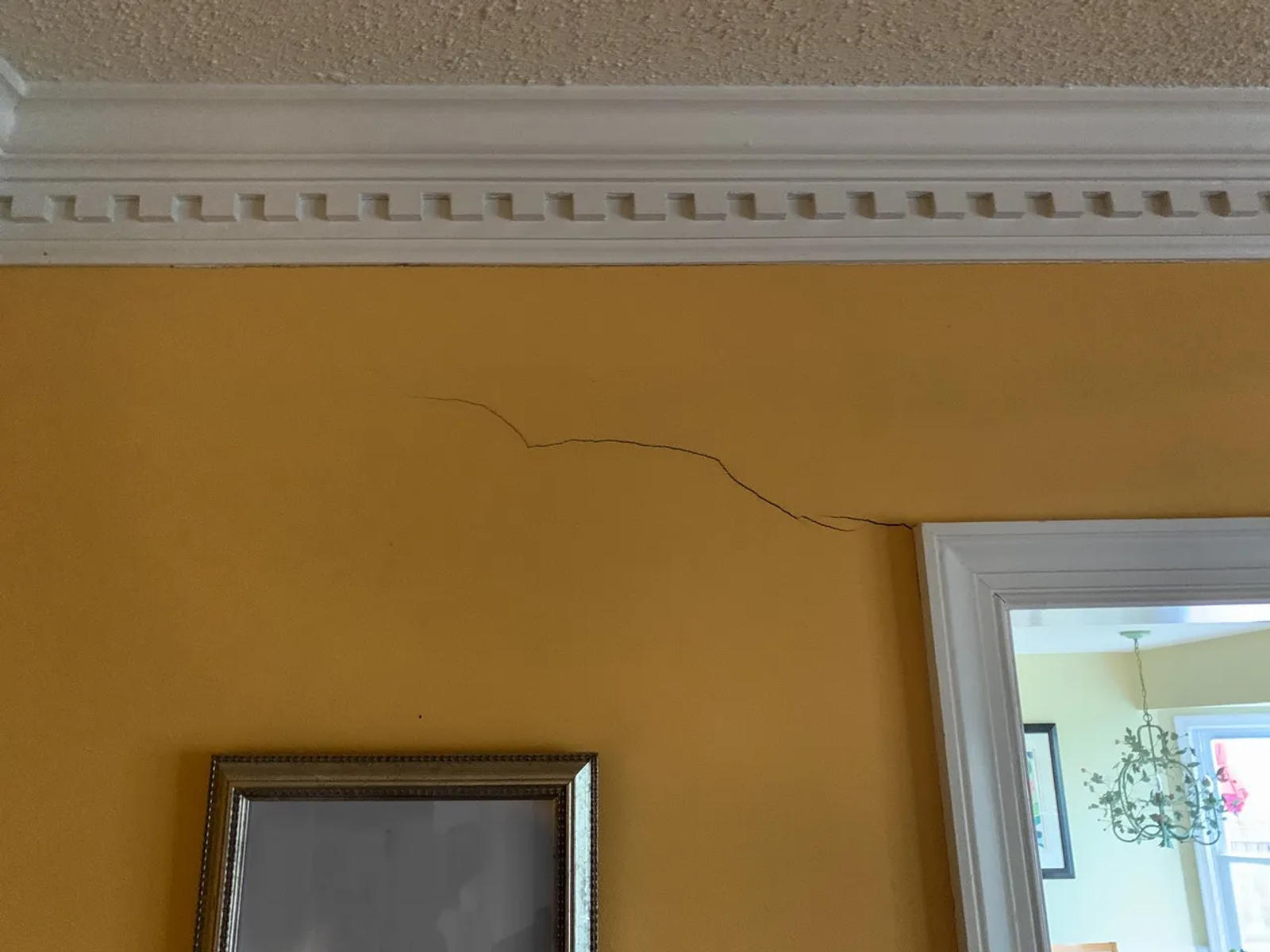 Crack on wall above an interior door.