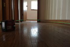 Laser level inspection on the uneven interior floor.