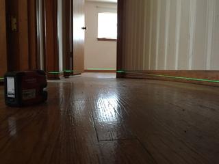 Laser level inspection on the uneven interior floor.