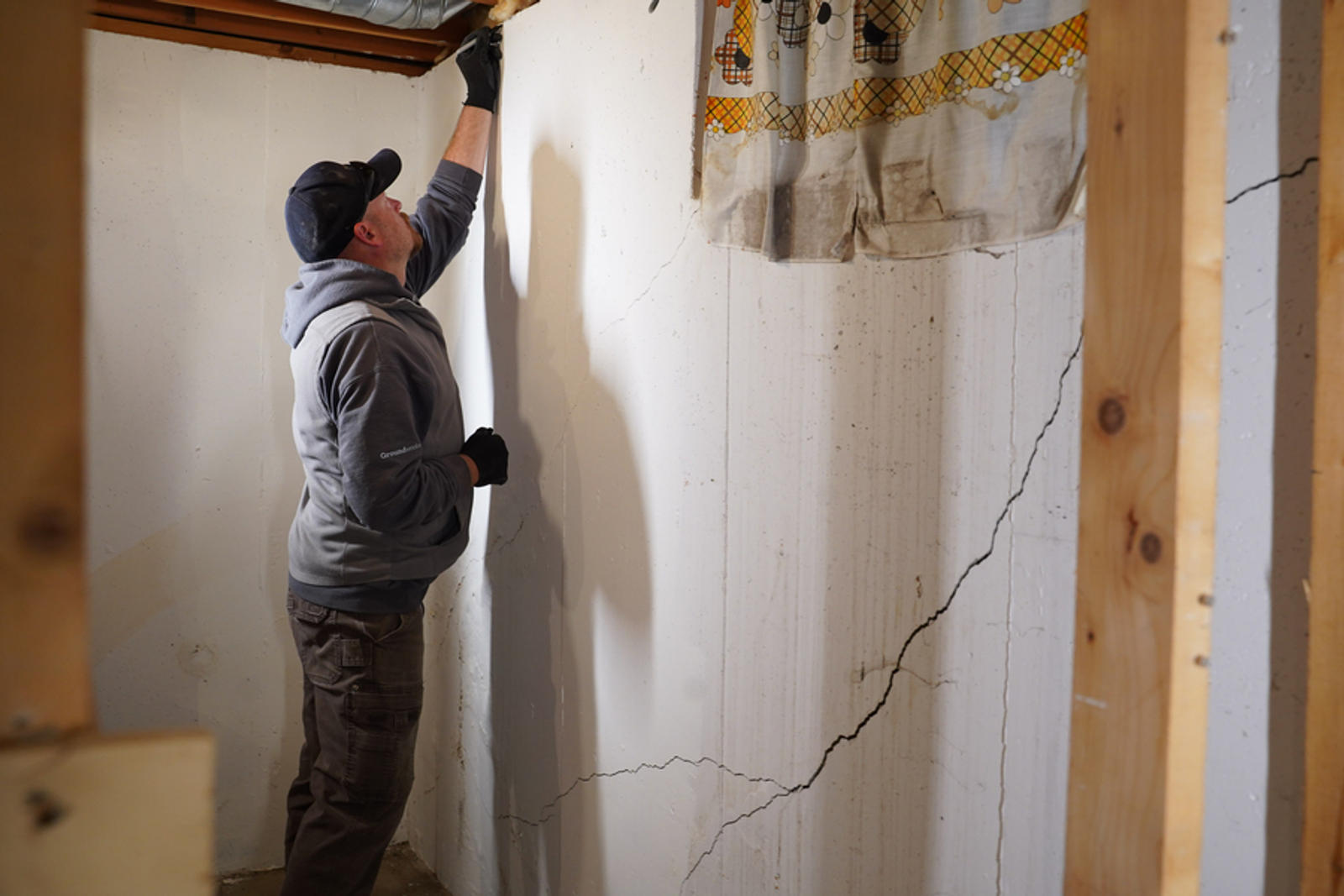 Groundworks worker fixing a cracked basement wall.